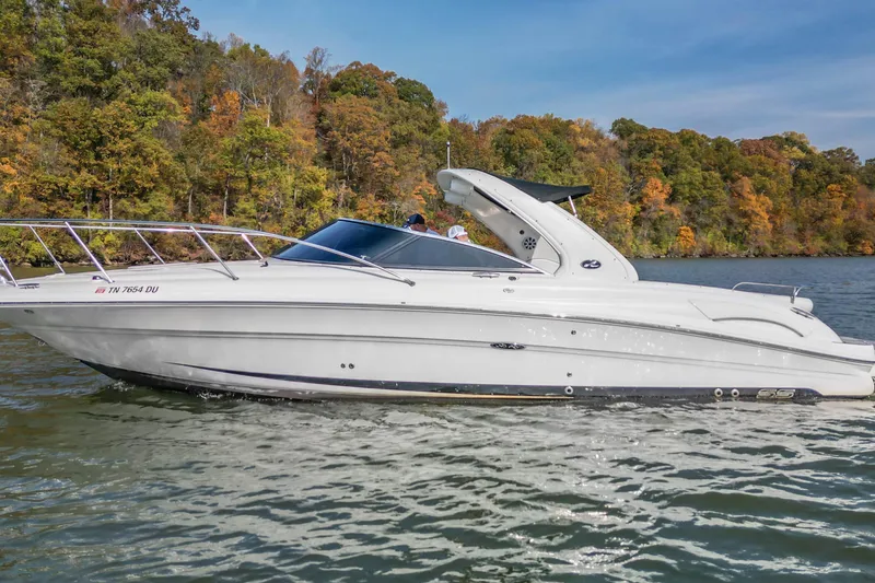 Slide: The Image of 2007 Sea Ray 290 Sun Sport boat cruising on a scenic lake with autumn foliage. - 2
