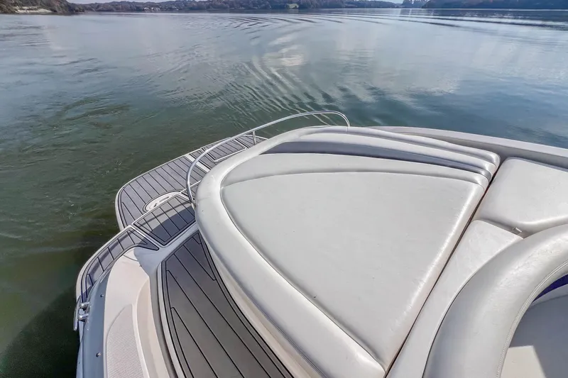 Slide: The Image of 2007 Sea Ray 290 Sun Sport boat on calm water, featuring spacious deck seating. - 24