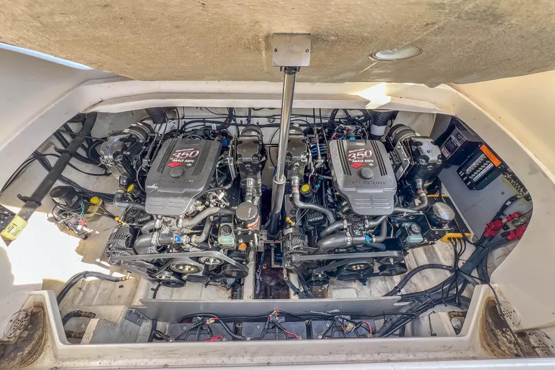 Slide: The Image of Twin Mercury engines in a 2007 Sea Ray 290 Sun Sport boat engine compartment. - 26