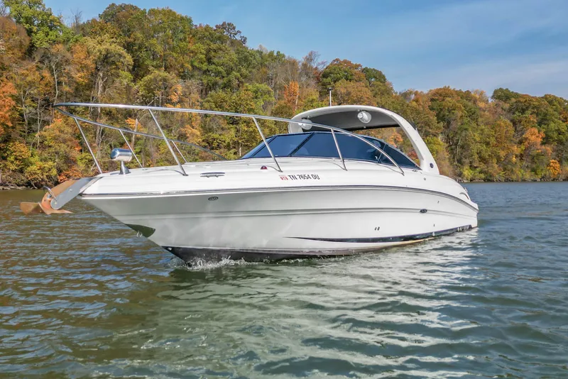 Slide: The Image of 2007 Sea Ray 290 Sun Sport boat cruising on a scenic lake with autumn foliage. - 3