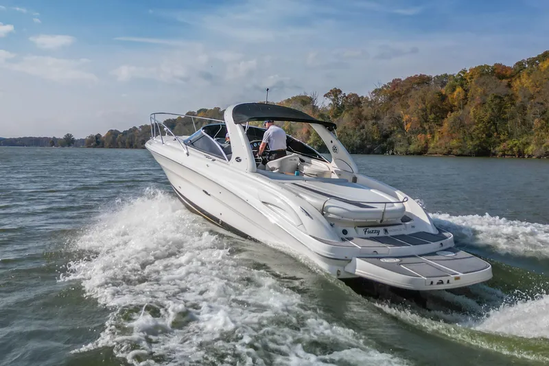 Slide: The Image of 2007 Sea Ray 290 Sun Sport cruising on a scenic lake with autumn foliage. - 5