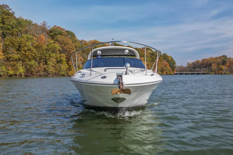 Slide: The Image of 2007 Sea Ray 290 Sun Sport boat cruising on a scenic lake with autumn foliage. - 6