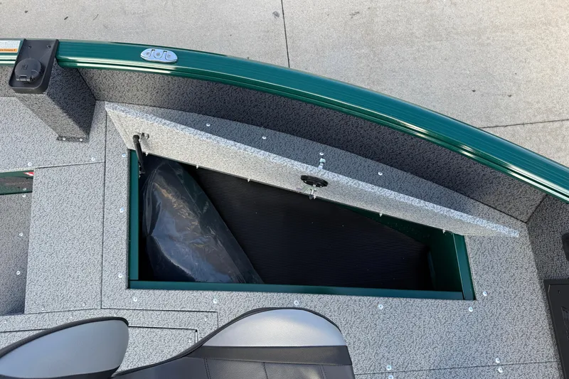 Slide: The Image of 2026 Lund 1700 Explorer Tiller boat storage compartment with open hatch, showcasing interior details. - 11