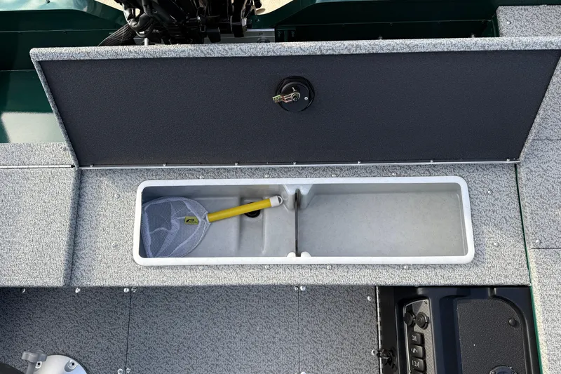 Slide: The Image of 2026 Lund 1700 Explorer Tiller boat storage compartment with fishing net and handle. - 19