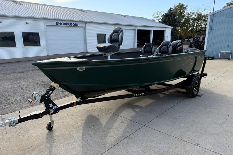 Slide: The Image of 2026 Lund 1700 Explorer Tiller boat on trailer outside showroom. - 3