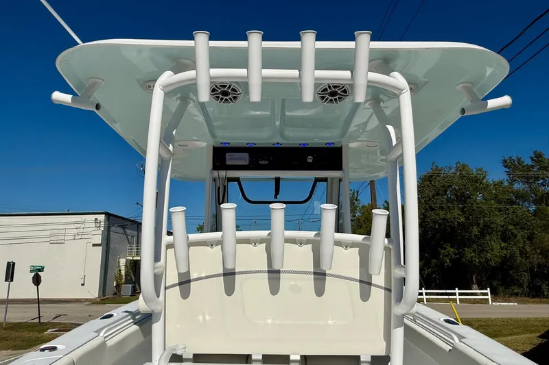 Slide: The Image of 2026 Sea Hunt Gamefish 30 Coffin Box boat with rod holders and speakers, under clear blue sky. - 12