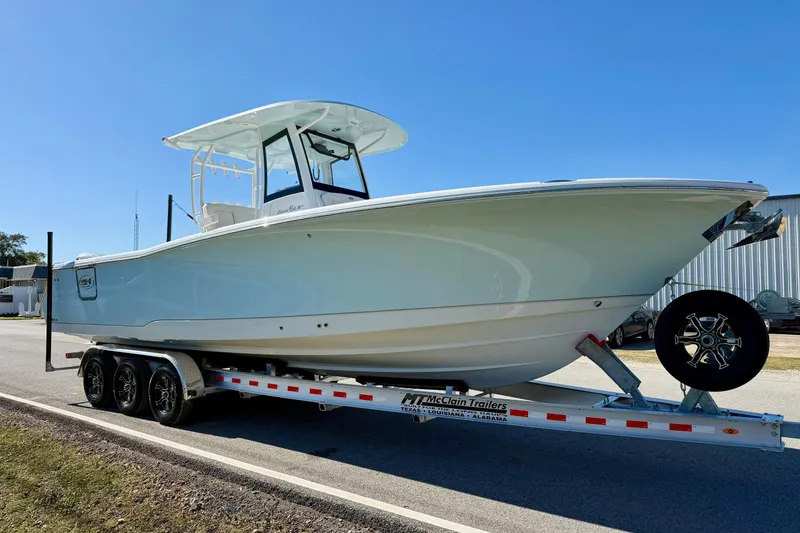 Slide: The Image of 2026 Sea Hunt Gamefish 30 Coffin Box boat on trailer, side view. - 5