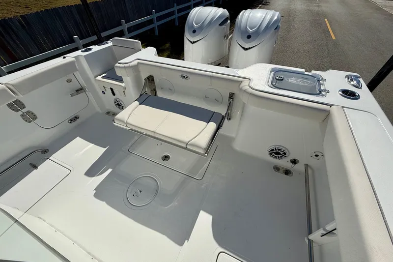 Slide: The Image of 2026 Sea Hunt Gamefish 30 Coffin Box boat interior with seating and dual engines. - 7
