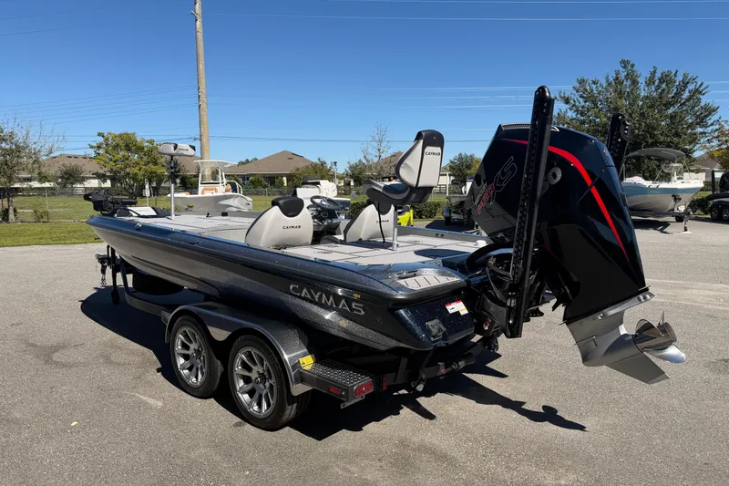 The Image of 2026 Caymas XS 21 Pro boat with powerful engine, parked outdoors on a sunny day. - 1