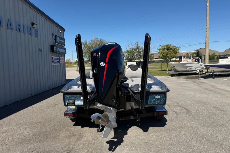 Slide: The Image of 2026 Caymas XS 21 Pro boat with powerful outboard motor, parked at a marine dealership. - 17