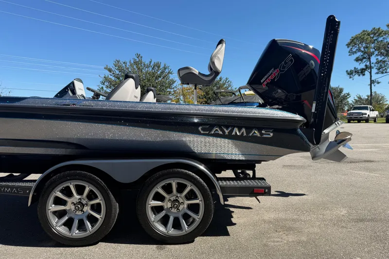 Slide: The Image of 2026 Caymas XS 21 Pro boat on trailer, featuring sleek design and powerful engine. - 2