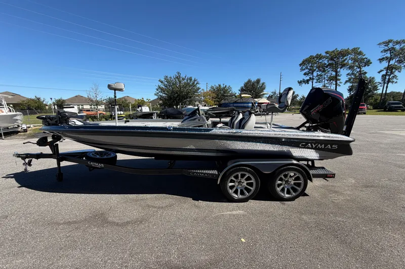Slide: The Image of 2026 Caymas XS 21 Pro boat on trailer in sunny parking lot. - 3