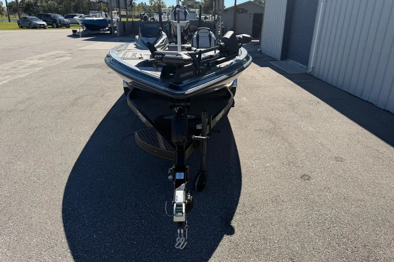Slide: The Image of 2026 Caymas XS 21 Pro boat parked outdoors on a sunny day. - 6