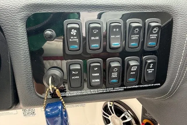 Slide: The Image of Control panel of 2021 Regal LS4 Surf boat with various switches and key ignition. - 10