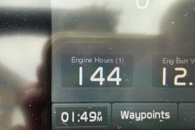 Slide: The Image of Display screen showing 144 engine hours on a 2021 Regal LS4 Surf boat. - 11