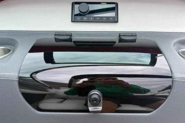 Slide: The Image of 2021 Regal LS4 Surf dashboard with control panel and storage compartment. - 14