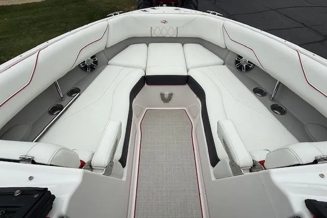 Slide: The Image of 2021 Regal LS4 Surf boat interior with white seating and red accents. - 17