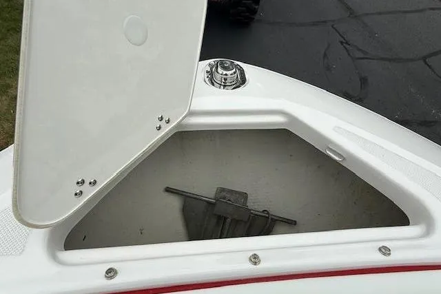 Slide: The Image of Open storage compartment on 2021 Regal LS4 Surf boat, showing anchor inside. - 19