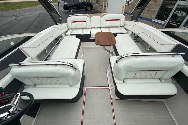 Slide: The Image of 2021 Regal LS4 Surf boat interior with luxurious white seating and wooden table. - 20