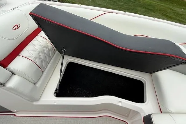 Slide: The Image of 2021 Regal LS4 Surf boat seat storage compartment with red and white upholstery. - 24