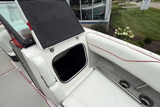 Slide: The Image of 2021 Regal LS4 Surf boat interior with white seating and storage compartment. - 25