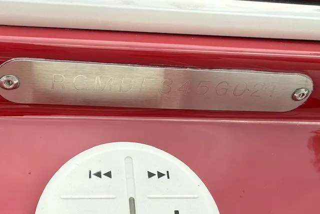 Slide: The Image of 2021 Regal LS4 Surf boat with engraved identification plate and control buttons. - 34