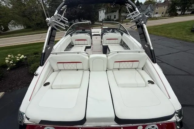 Slide: The Image of 2021 Regal LS4 Surf boat with luxurious white seating and sleek design. - 4