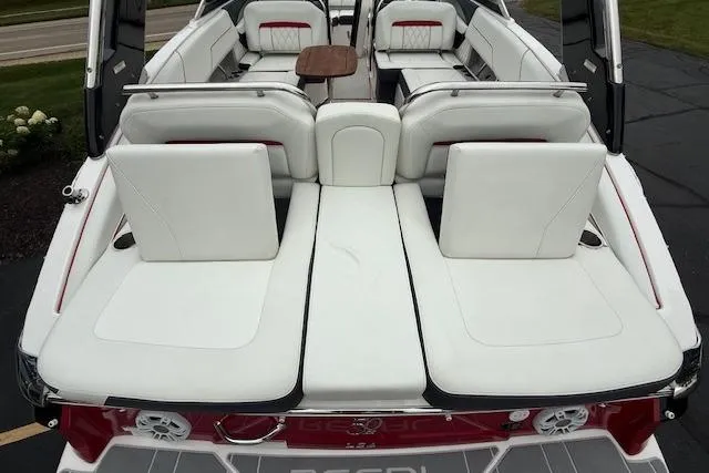 Slide: The Image of 2021 Regal LS4 Surf boat interior with white seating and wooden table. - 5