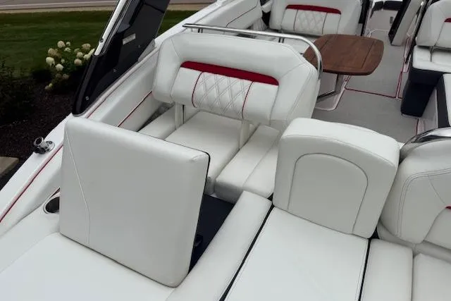 Slide: The Image of 2021 Regal LS4 Surf boat interior with white leather seating and red accents. - 6