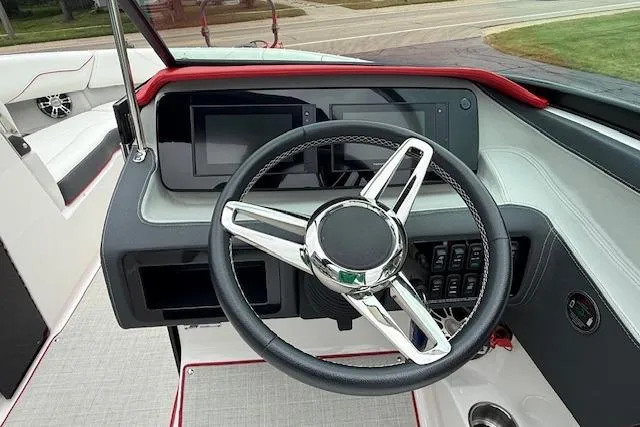 Slide: The Image of 2021 Regal LS4 Surf boat dashboard with modern steering wheel and digital displays. - 9