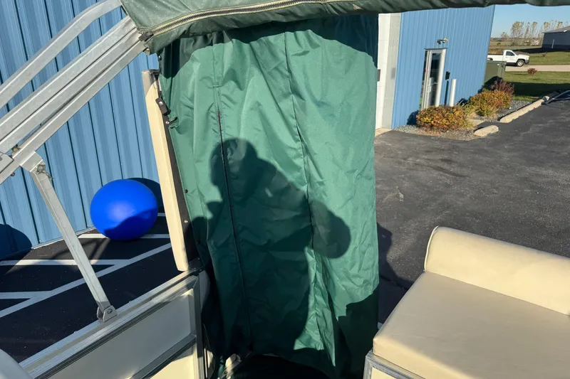 Slide: The Image of 2003 Odyssey Pontoons 2102 Millennium with green canopy and beige seating. - 13