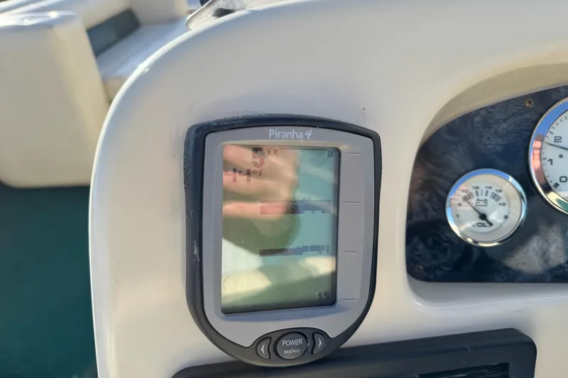 Slide: The Image of Close-up of a 2003 Odyssey Pontoons 2102 Millennium dashboard with Piranha 4 fish finder. - 22
