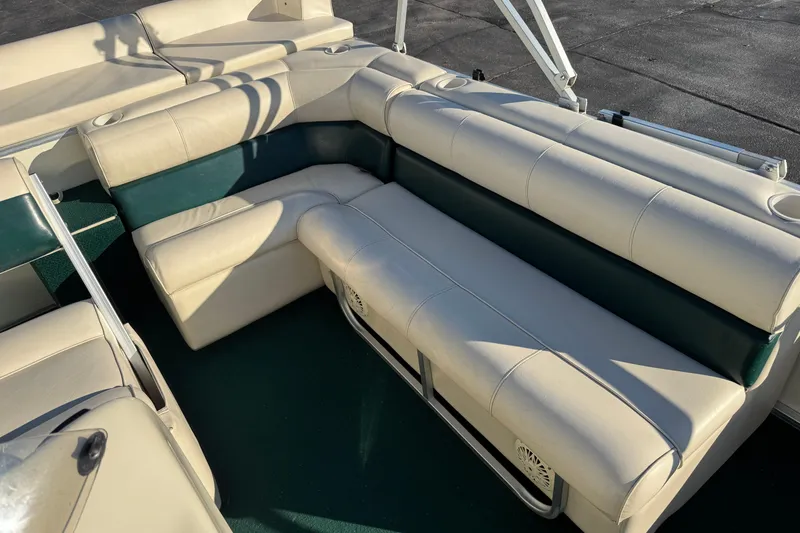 Slide: The Image of 2003 Odyssey Pontoons 2102 Millennium boat interior with beige and green seating. - 25