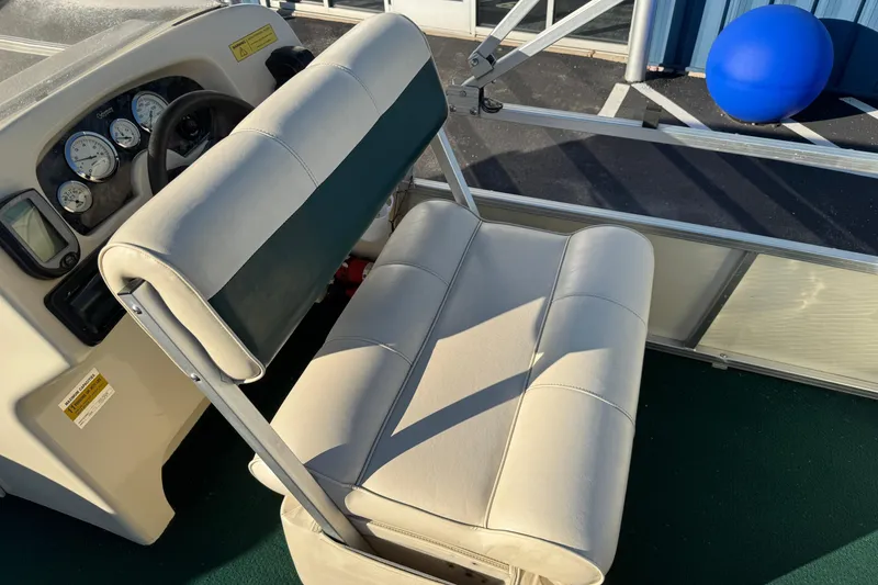 Slide: The Image of 2003 Odyssey Pontoons 2102 Millennium boat interior with steering console and cushioned seating. - 28