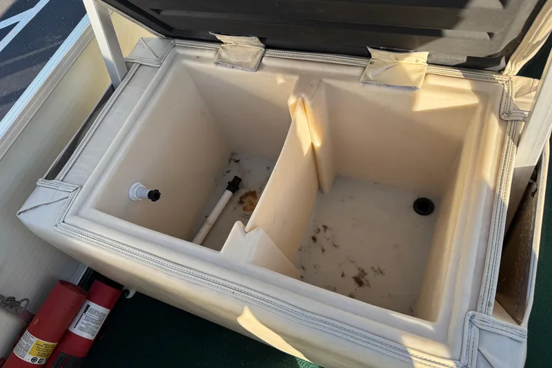 Slide: The Image of Open storage compartment on 2003 Odyssey Pontoons 2102 Millennium boat. - 29