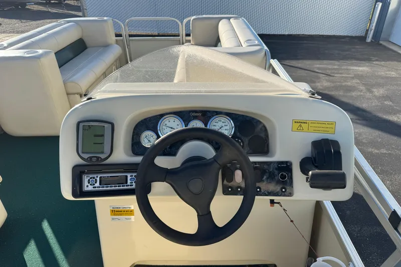 Slide: The Image of 2003 Odyssey Pontoons 2102 Millennium boat dashboard with steering wheel and gauges. - 30