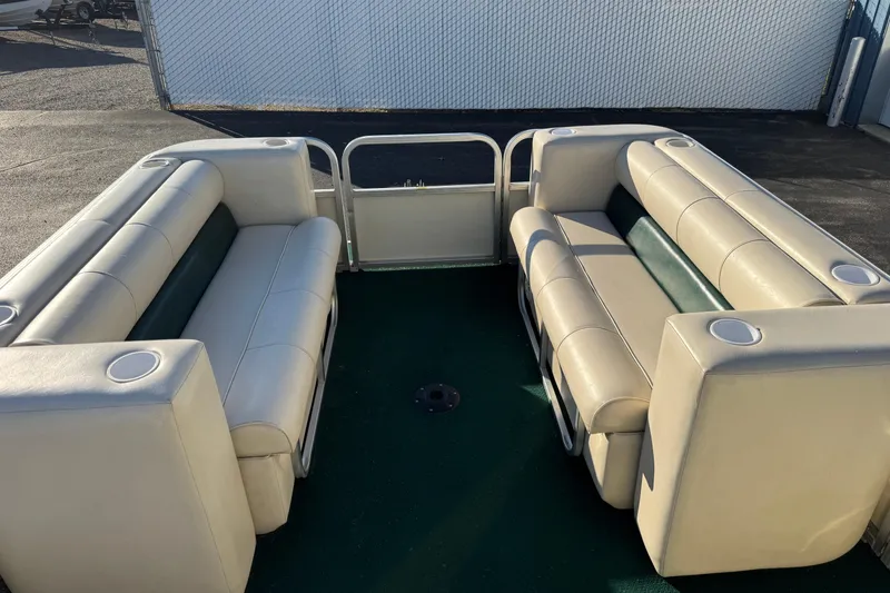 Slide: The Image of 2003 Odyssey Pontoons 2102 Millennium interior with beige seating and cup holders. - 5