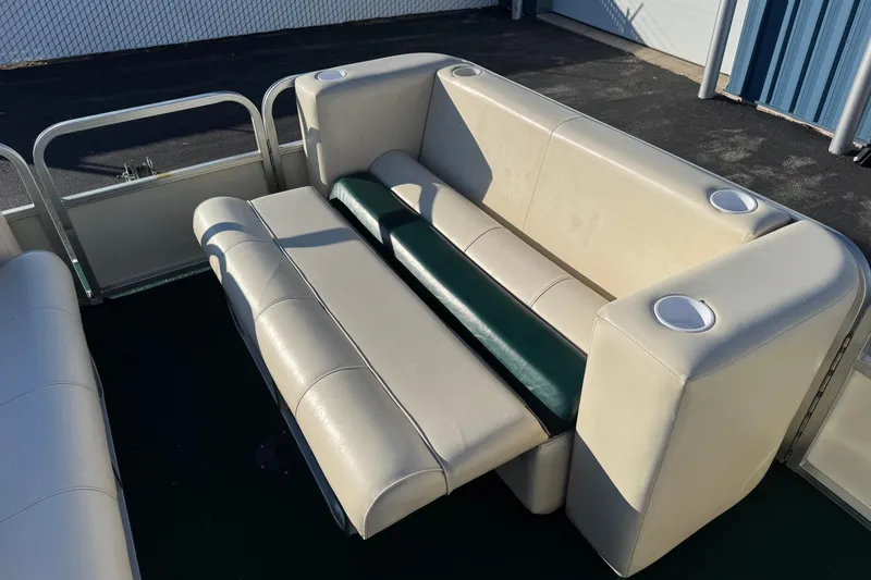 Slide: The Image of 2003 Odyssey Pontoons 2102 Millennium boat seating with cup holders, beige and green upholstery. - 7