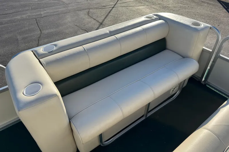 Slide: The Image of 2003 Odyssey Pontoons 2102 Millennium boat seating with cup holders, outdoor setting. - 8