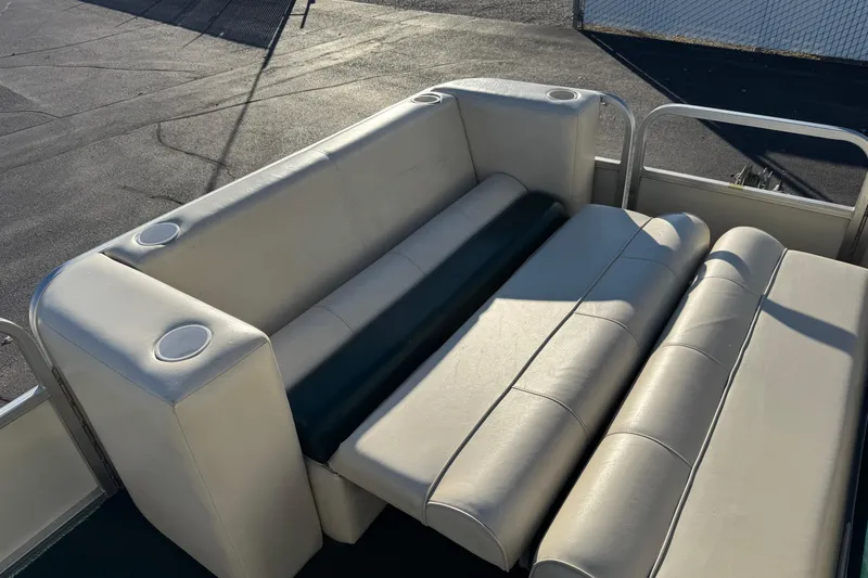 Slide: The Image of 2003 Odyssey Pontoons 2102 Millennium boat seating with cup holders, outdoor setting. - 9