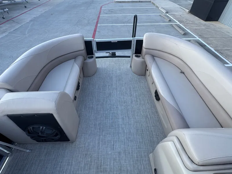 Slide: The Image of 2017 Avalon LSZ rf 2285 pontoon boat interior with beige seating and cup holders. - 15
