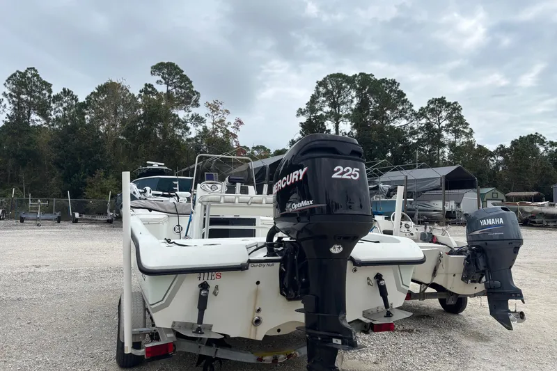 Slide: The Image of 2007 Action Craft Coastal Craft boat with Mercury and Yamaha outboard motors, parked outdoors. - 5