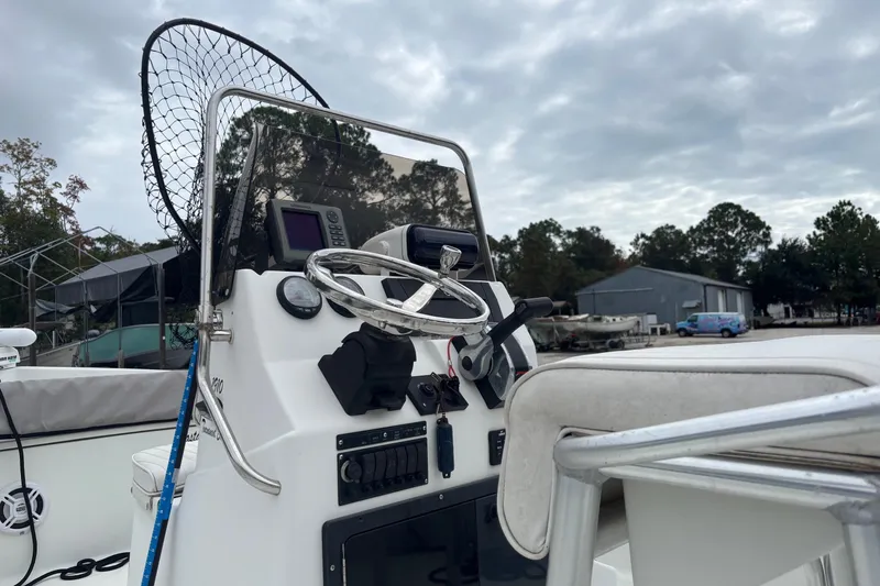 Slide: The Image of 2007 Action Craft Coastal Craft boat console with steering wheel and fishing net. - 6