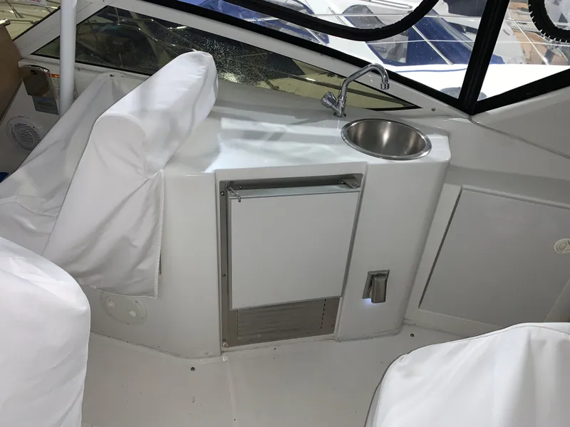 Slide: The Image of 2001 Carver 396 Motor Yacht interior with sink and covered seating area. - 15
