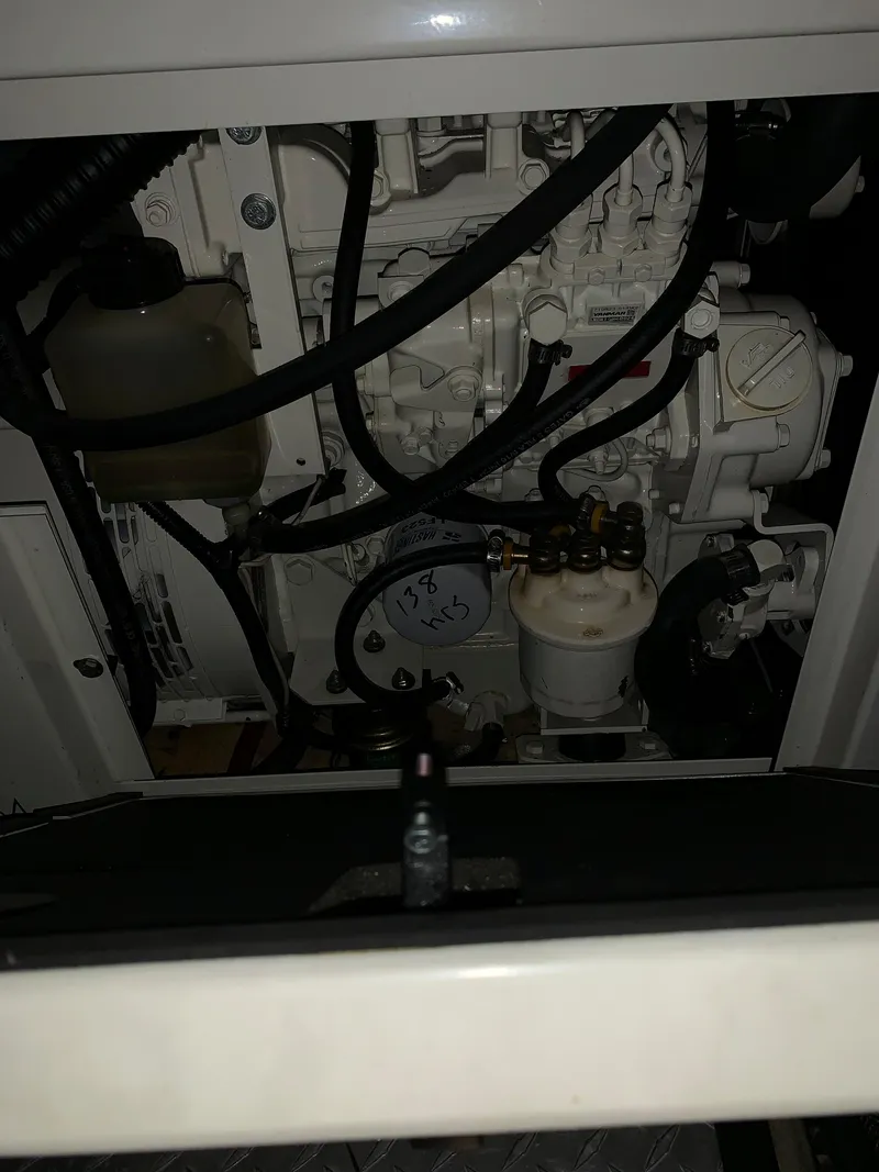 Slide: The Image of Engine compartment of a 2001 Carver 396 Motor Yacht, showcasing mechanical components. - 22