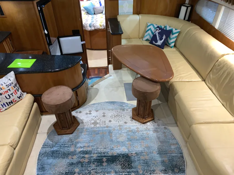 Slide: The Image of Interior of 2001 Carver 396 Motor Yacht with beige seating and nautical decor. - 23