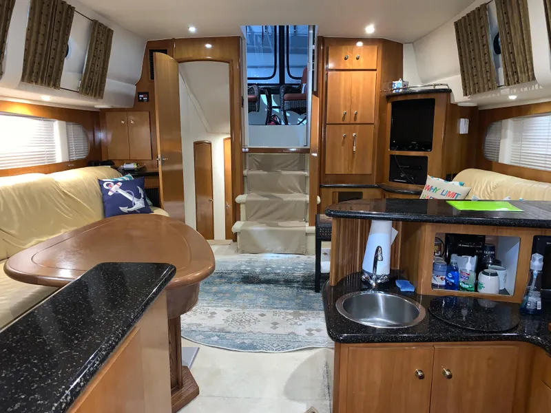 Slide: The Image of Interior of 2001 Carver 396 Motor Yacht with modern kitchen and cozy seating area. - 28