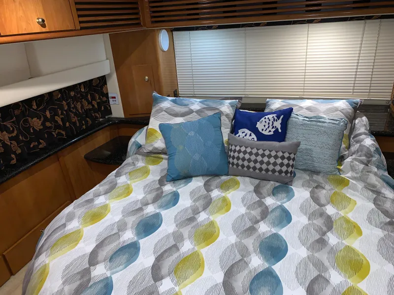 Slide: The Image of Cozy bedroom in 2001 Carver 396 Motor Yacht with colorful bedding and decorative pillows. - 30