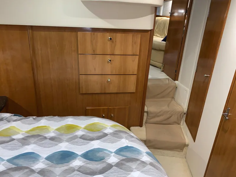 Slide: The Image of Interior of 2001 Carver 396 Motor Yacht with wooden cabinetry and patterned bedding. - 31