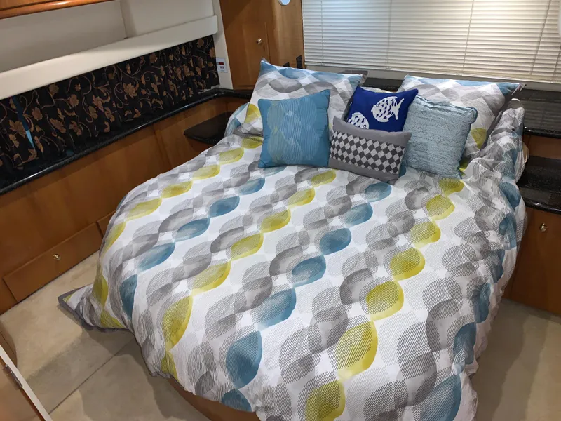 Slide: The Image of Cozy bedroom in 2001 Carver 396 Motor Yacht with colorful bedding and decorative pillows. - 35